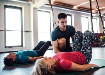 Doing pilates in a studio with an instructor