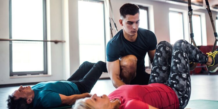 Doing pilates in a studio with an instructor